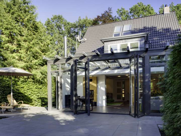 Der Solarlux Wintergarten verschafft dem Bauherrenpaar einen großzügigen, offenen Wohnraum und einen ganzjährigen Platz im Garten.    Bildnachweis: Jan Haeselich für Solarlux GmbH